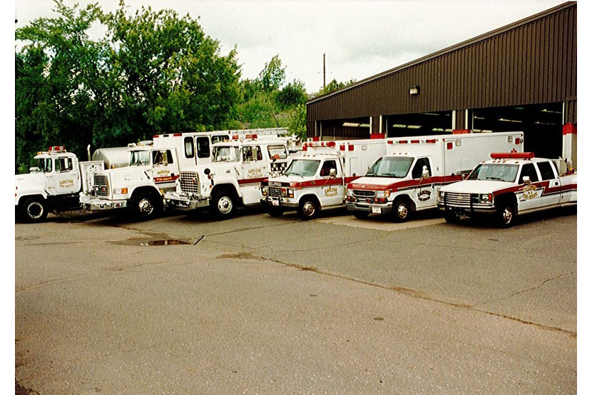 fire trucks and ambulances parking in front of the